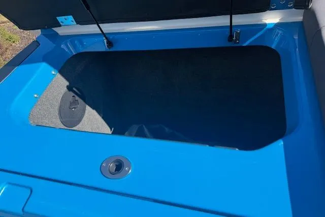 Slide: The Image of 2020 Moomba Makai boat storage compartment with blue exterior and open lid. - 25