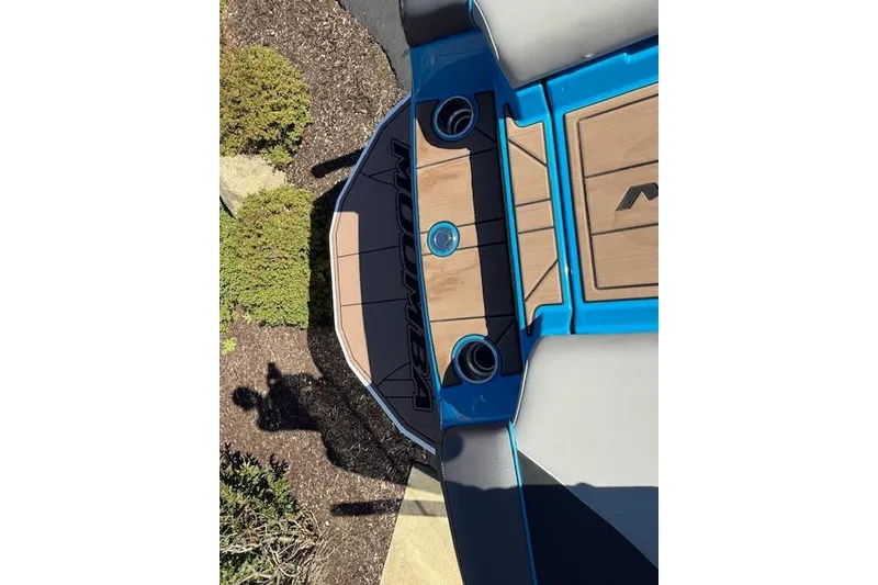 Slide: The Image of 2020 Moomba Makai boat deck with blue accents and wood finish. - 26