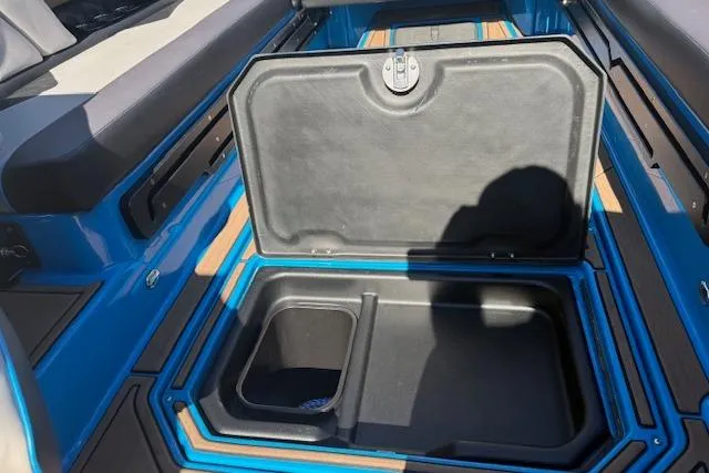 Slide: The Image of 2020 Moomba Makai boat storage compartment with open lid, showcasing interior space. - 28