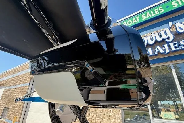 Slide: The Image of 2020 Moomba Makai boat detail at dealership, showcasing sleek black and white design. - 32