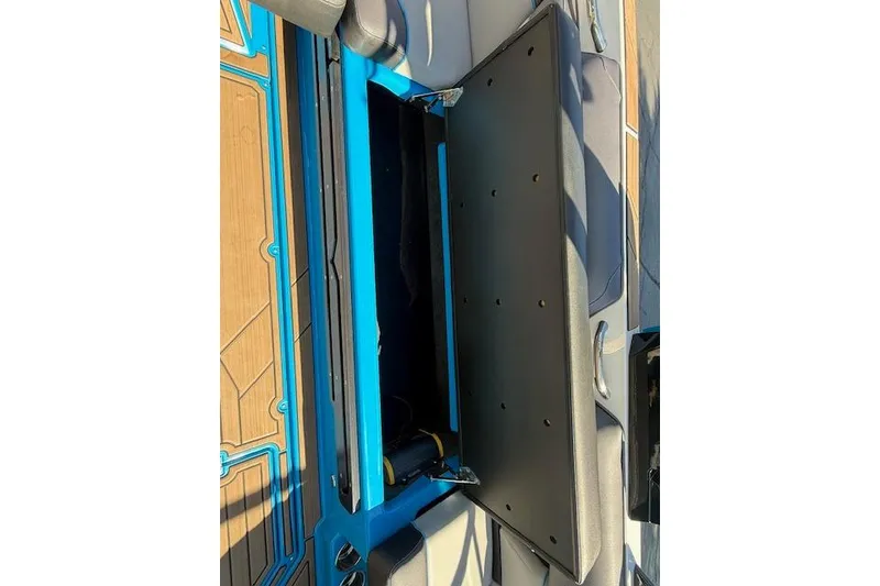 Slide: The Image of 2020 Moomba Makai boat interior storage compartment with blue and black accents. - 35