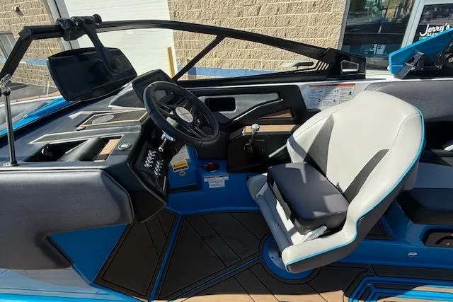 Slide: The Image of 2020 Moomba Makai boat interior with steering wheel and captain's seat, featuring blue accents. - 6