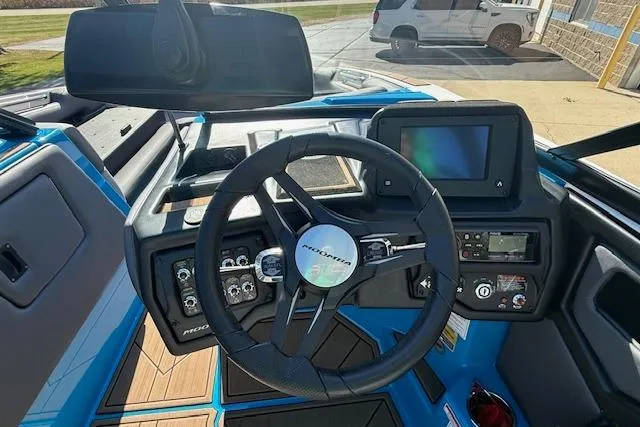 Slide: The Image of 2020 Moomba Makai boat dashboard with steering wheel and control panel. - 7