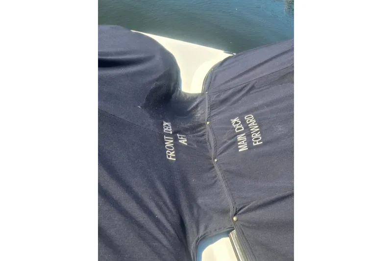 Slide: The Image of 2016 Hurricane SunDeck 2200 DC OB boat cover with labeled sections on water. - 15