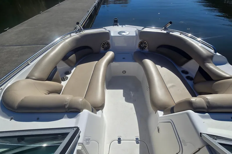Slide: The Image of 2016 Hurricane SunDeck 2200 DC OB boat interior with beige seating and cup holders. - 5