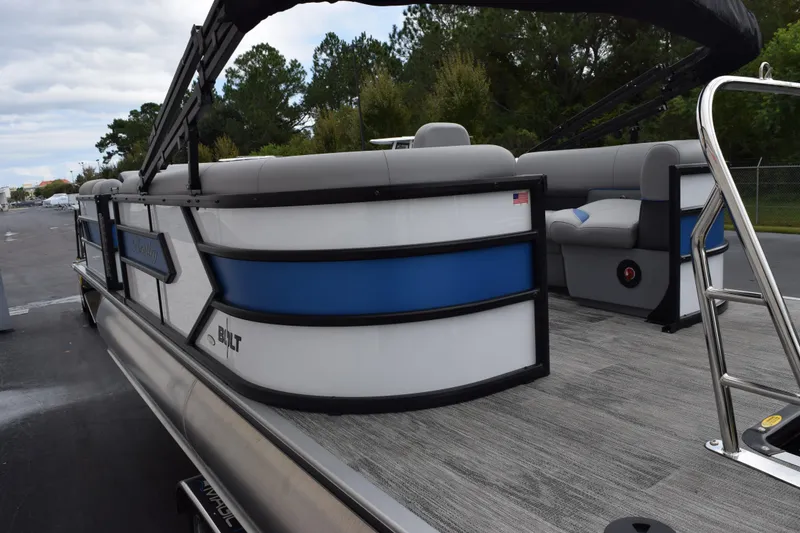 Slide: The Image of 2026 Bentley Pontoons Bolt 223, sleek design with blue and white accents, docked outdoors. - 7