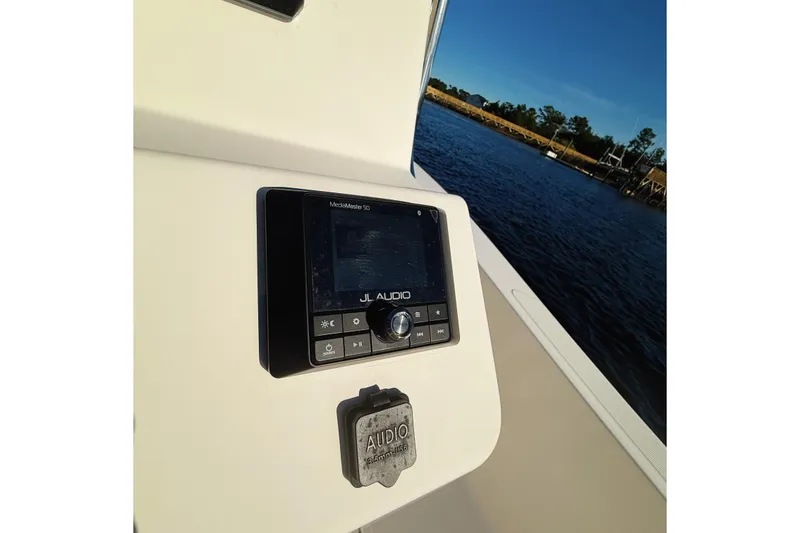 Slide: The Image of 2019 Pioneer 175 Baysport boat with JL Audio system by the water. - 10