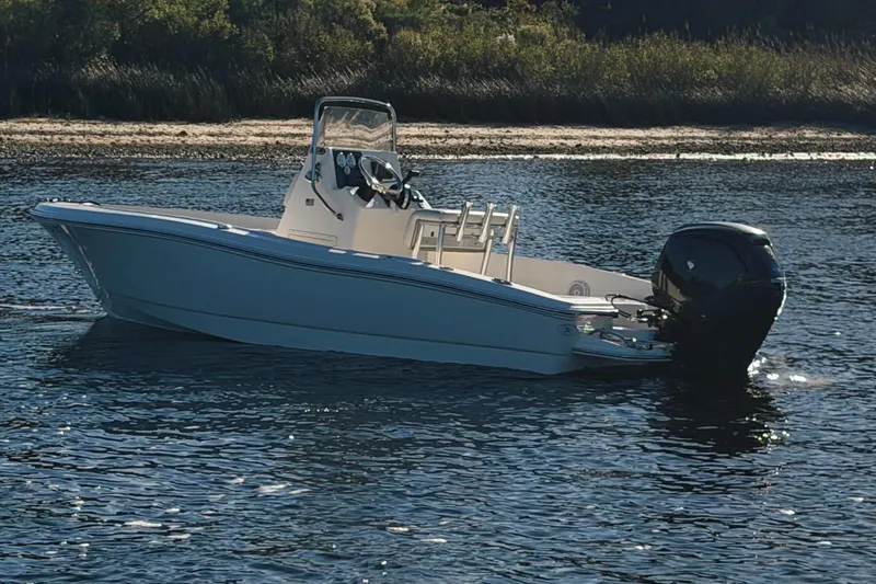 Slide: The Image of 2019 Pioneer 175 Baysport boat on calm water near a sandy shore. - 2