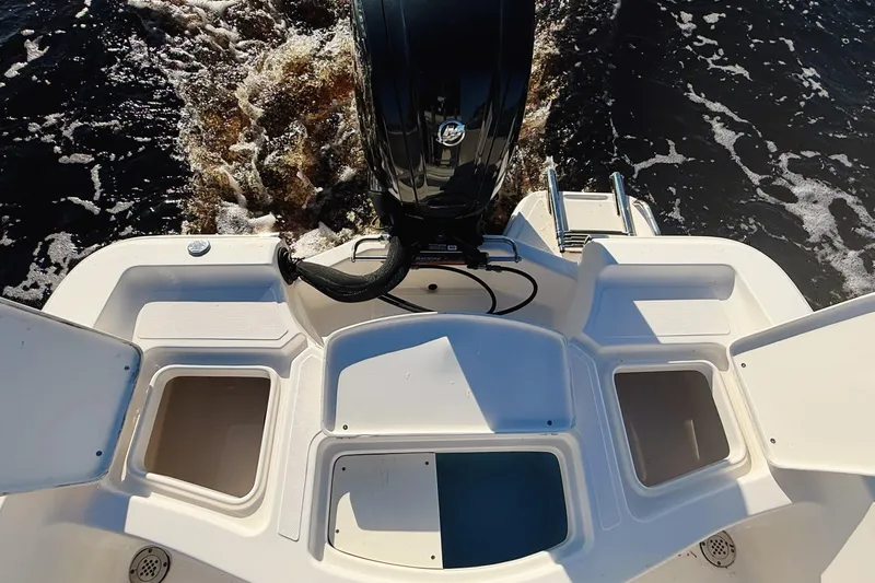 Slide: The Image of 2019 Pioneer 175 Baysport boat stern with motor and storage compartments. - 6