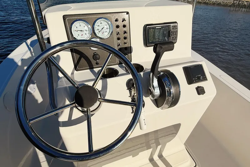 Slide: The Image of 2019 Pioneer 175 Baysport boat dashboard with steering wheel and navigation instruments. - 7