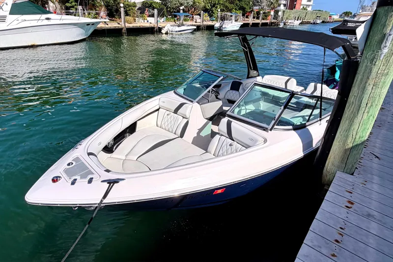 Slide: The Image of 2020 Regal 2300 Bowrider docked in a marina, featuring sleek design and spacious seating. - 1
