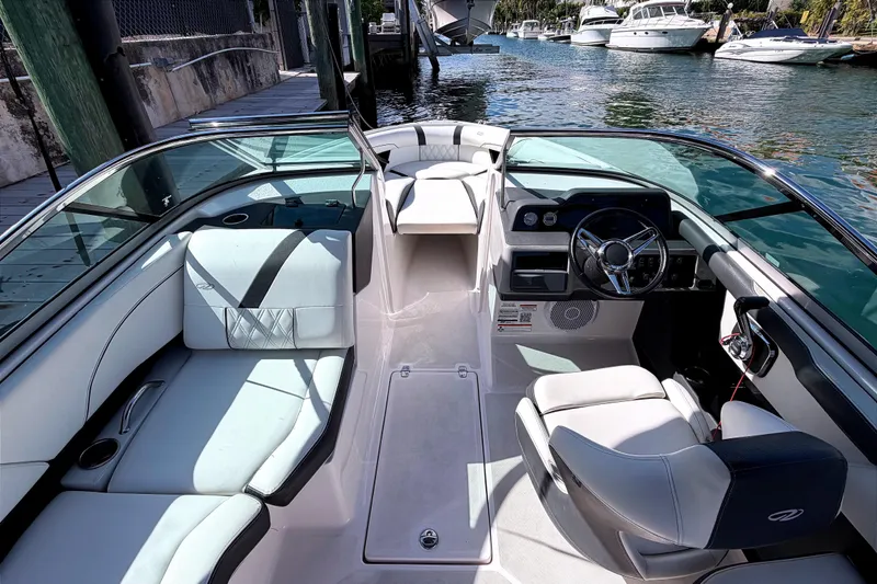 Slide: The Image of 2020 Regal 2300 Bowrider interior with sleek seating and modern dashboard on a sunny day. - 10