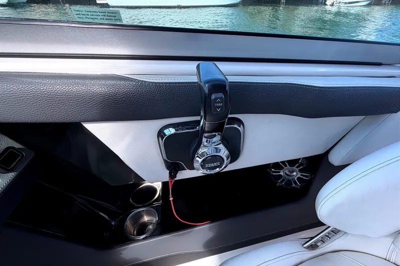 Slide: The Image of Interior of 2020 Regal 2300 Bowrider boat with throttle control and cup holders. - 17