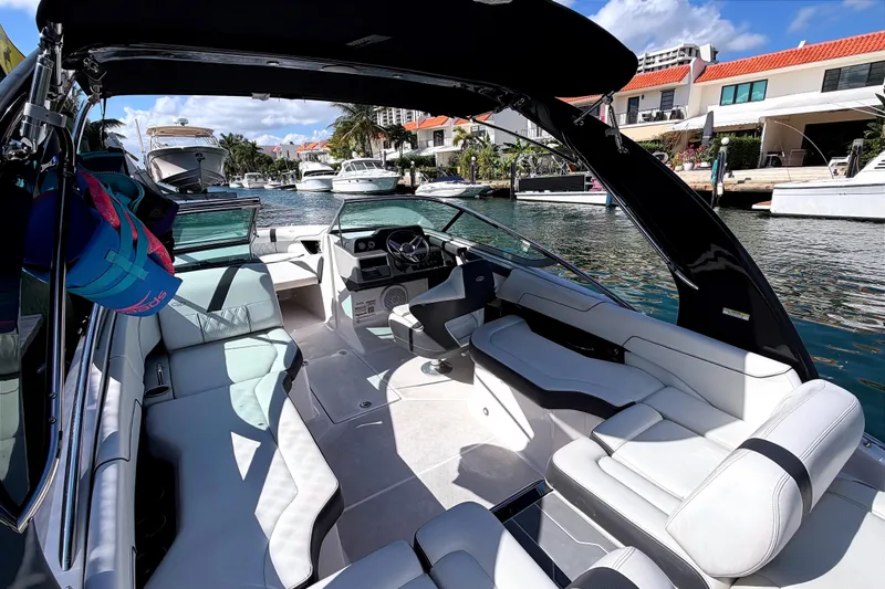 Slide: The Image of 2020 Regal 2300 Bowrider boat interior with luxurious seating and waterfront view. - 6