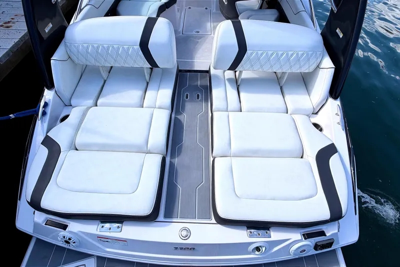 Slide: The Image of 2020 Regal 2300 Bowrider boat with luxurious white seating and sleek design. - 8