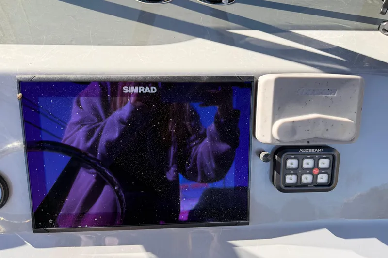 Slide: The Image of Dashboard of 2022 Shoalwater 23 Catamaran with Simrad display and Auxbeam controls. - 13