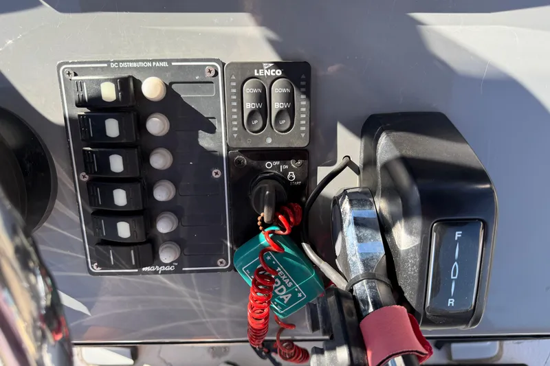 Slide: The Image of Control panel of a 2022 Shoalwater 23 Catamaran with switches and throttle. - 14