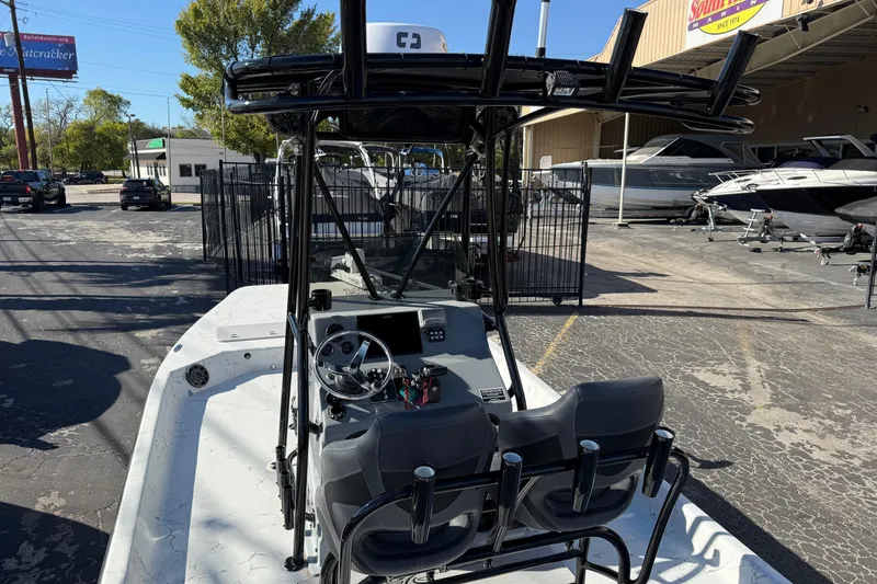 Slide: The Image of 2022 Shoalwater 23 Catamaran boat with dual seats and steering console in a marina setting. - 15