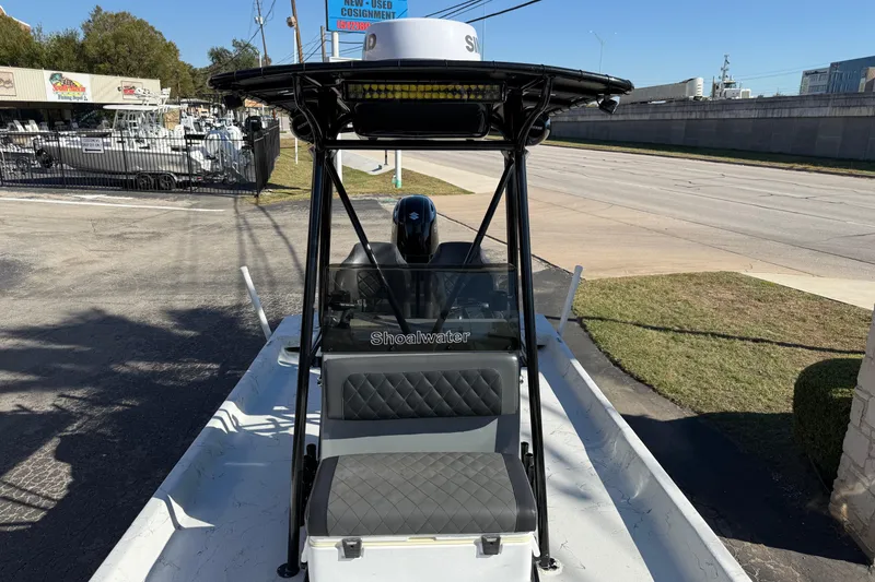 Slide: The Image of 2022 Shoalwater 23 Catamaran boat parked near a road, showcasing sleek design and seating. - 21