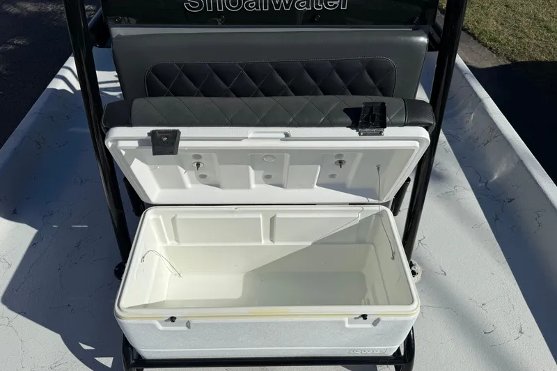 Slide: The Image of Open cooler on 2022 Shoalwater 23 Catamaran boat with cushioned seating. - 25