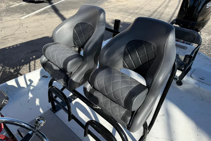 Slide: The Image of Luxury seating on 2022 Shoalwater 23 Catamaran, featuring sleek black and gray design. - 26