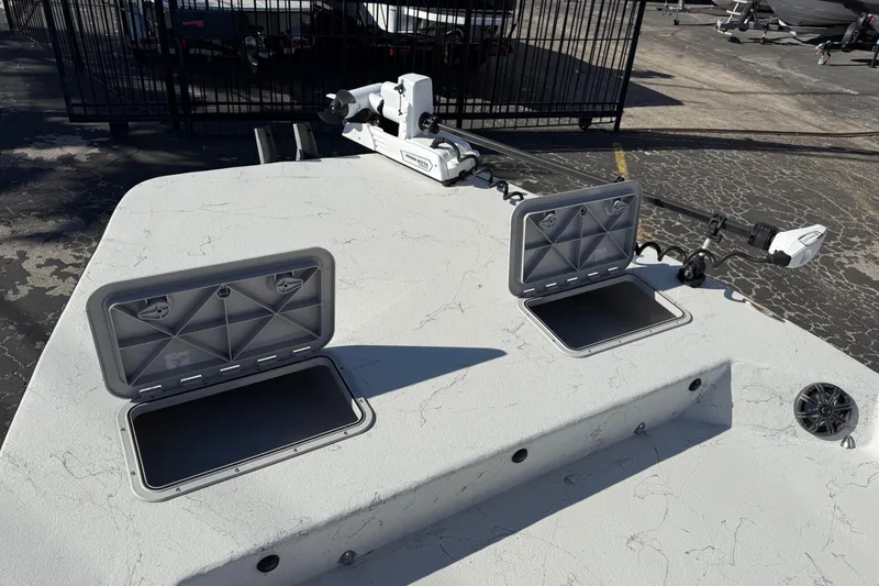 Slide: The Image of 2022 Shoalwater 23 Catamaran deck with open storage compartments and trolling motor. - 33