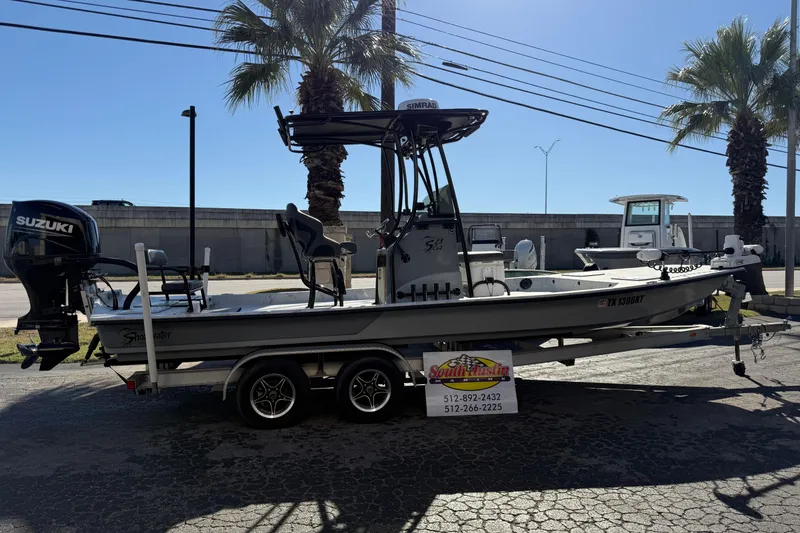 Slide: The Image of 2022 Shoalwater 23 Catamaran boat on trailer, featuring Suzuki outboard motor. - 37
