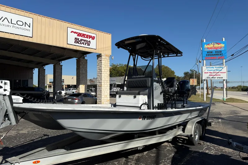 Slide: The Image of 2022 Shoalwater 23 Catamaran boat on trailer outside dealership under clear blue sky. - 5