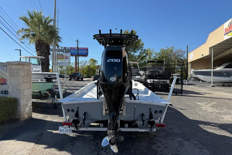 Slide: The Image of 2022 Shoalwater 23 Catamaran with 200 HP engine, parked outdoors on a sunny day. - 6