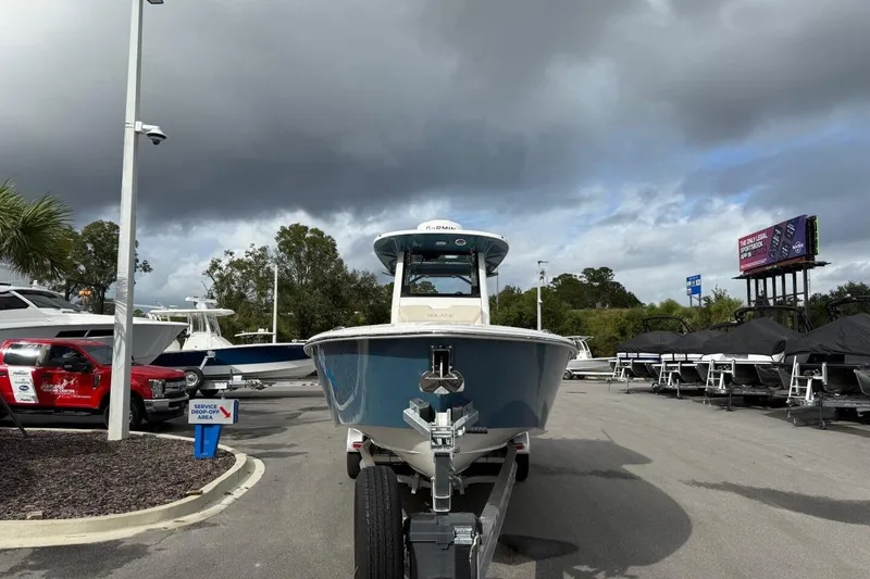 Slide: The Image of 2025 Solace 28 HCS boat on trailer in dealership lot under cloudy sky. - 1