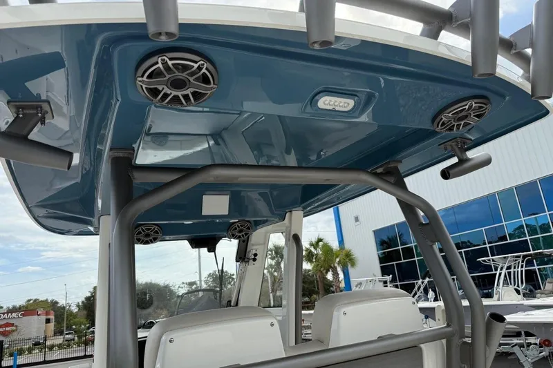 Slide: The Image of 2025 Solace 28 HCS boat with blue canopy, speakers, and rod holders. - 10