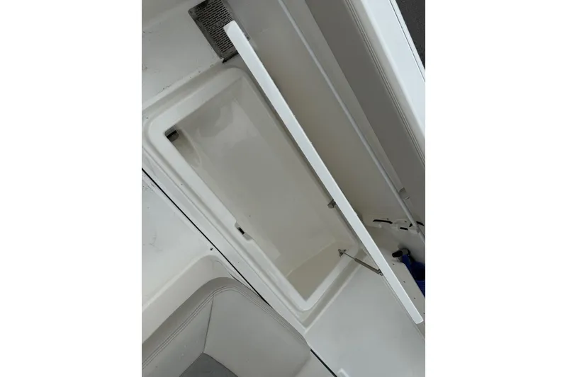Slide: The Image of Open storage compartment on 2025 Solace 28 HCS boat, showcasing interior space. - 11