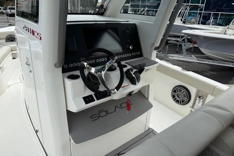 Slide: The Image of Helm of 2025 Solace 28 HCS boat with modern steering and control panel. - 12
