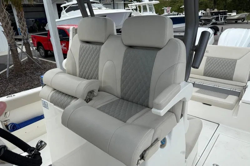 Slide: The Image of Luxury seating on 2025 Solace 28 HCS boat, featuring quilted upholstery and armrests. - 13