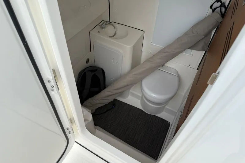 Slide: The Image of Compact bathroom in 2025 Solace 28 HCS boat, featuring toilet and sink. - 15