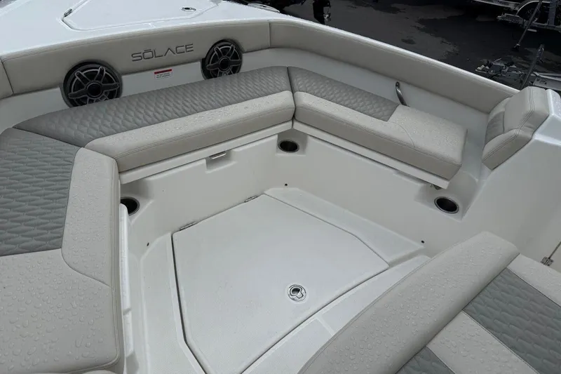 Slide: The Image of 2025 Solace 28 HCS boat interior with cushioned seating and speakers. - 17