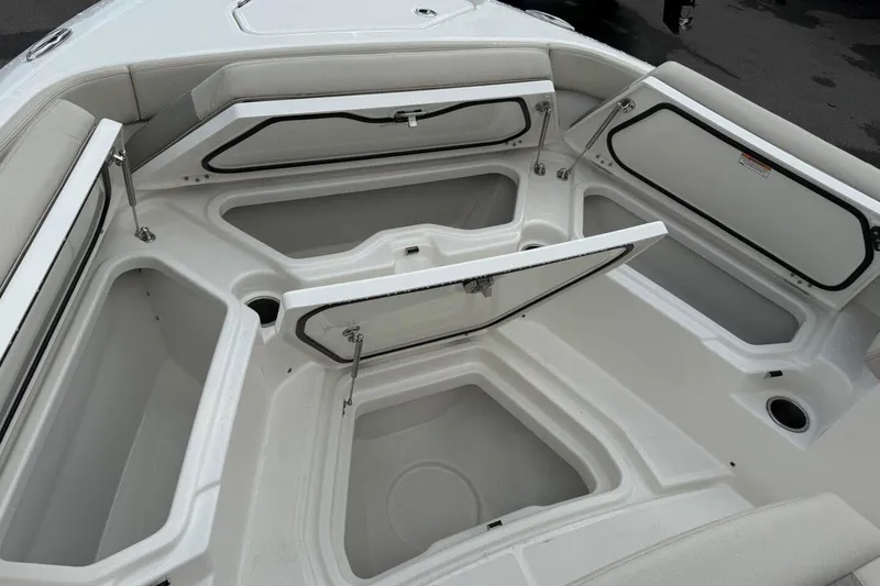 Slide: The Image of Open storage compartments on a 2025 Solace 28 HCS boat deck. - 22