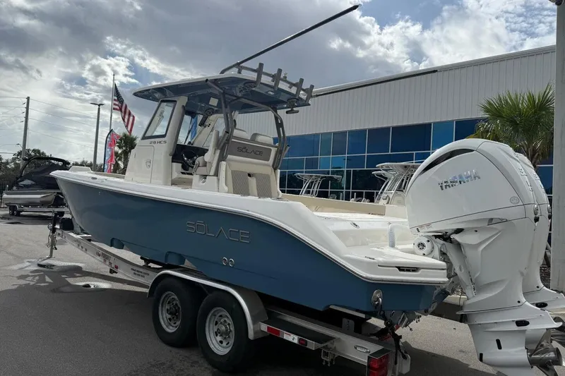 Slide: The Image of 2025 Solace 28 HCS boat on trailer, featuring sleek design and powerful engine. - 3
