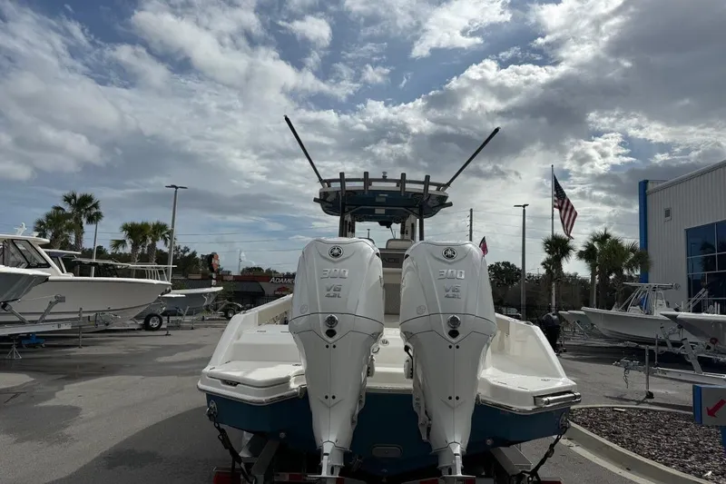Slide: The Image of 2025 Solace 28 HCS boat with dual 300 V6 engines, displayed outdoors under cloudy sky. - 4