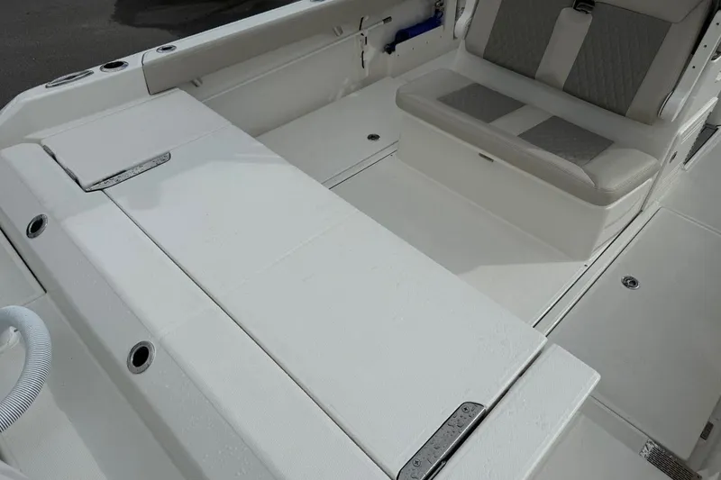 Slide: The Image of 2025 Solace 28 HCS boat interior with cushioned seating and storage compartments. - 5