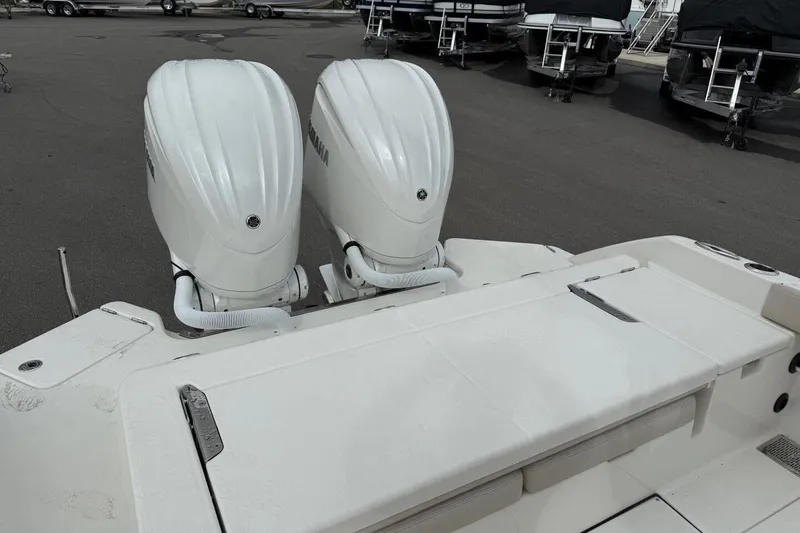 Slide: The Image of 2025 Solace 28 HCS boat with dual outboard engines in a marina setting. - 6