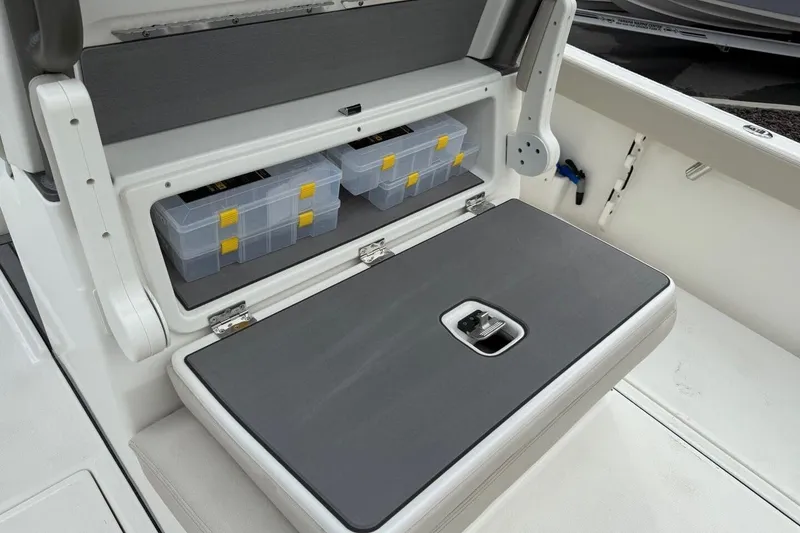 Slide: The Image of Storage compartment on 2025 Solace 28 HCS boat with organized tackle boxes. - 9