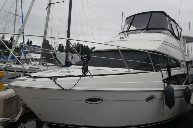 Slide: The Image of 2006 Carver 366 Motor Yacht docked at marina, featuring sleek design and spacious deck. - 1