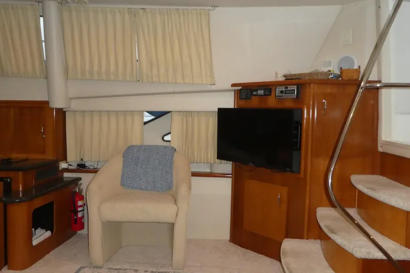Slide: The Image of Interior of 2006 Carver 366 Motor Yacht with chair, TV, and stairs. - 12