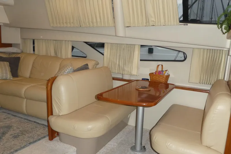Slide: The Image of Interior of 2006 Carver 366 Motor Yacht with beige seating and wooden table. - 14