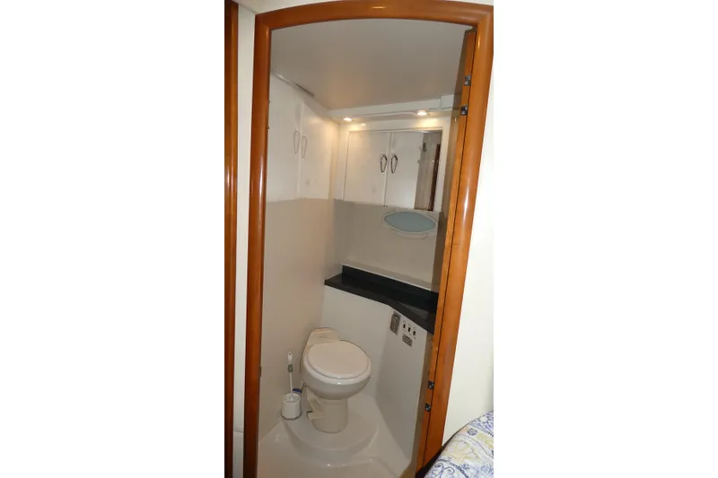 Slide: The Image of Bathroom interior of 2006 Carver 366 Motor Yacht, featuring toilet and storage cabinets. - 23
