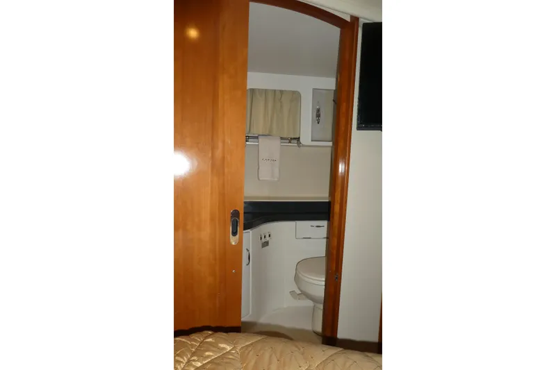 Slide: The Image of 2006 Carver 366 Motor Yacht bathroom with wooden door and compact design. - 30