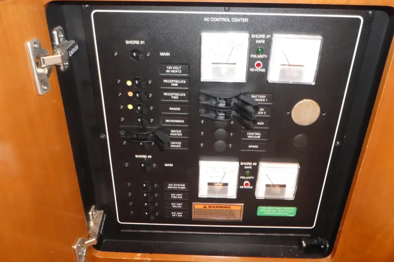 Slide: The Image of AC control panel of 2006 Carver 366 Motor Yacht with various switches and meters. - 40