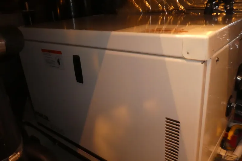 Slide: The Image of Engine room of 2006 Carver 366 Motor Yacht, featuring a white generator unit. - 48