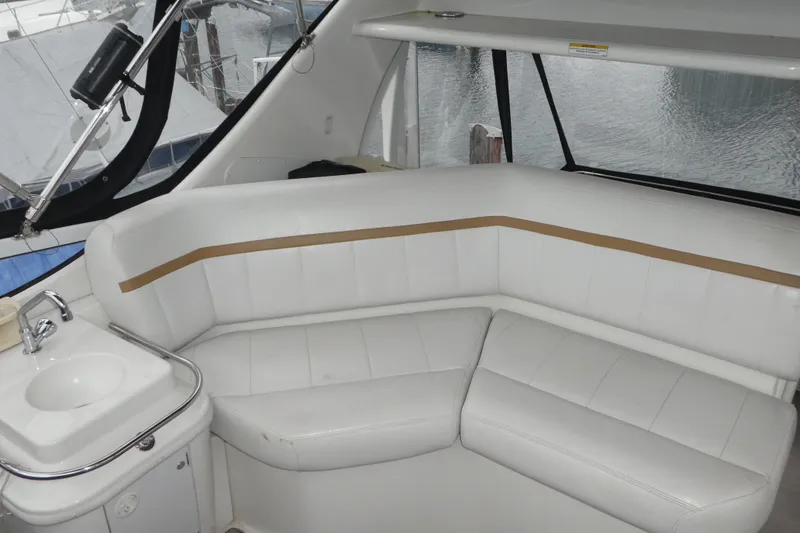 Slide: The Image of 2006 Carver 366 Motor Yacht interior with white seating and small sink. - 6